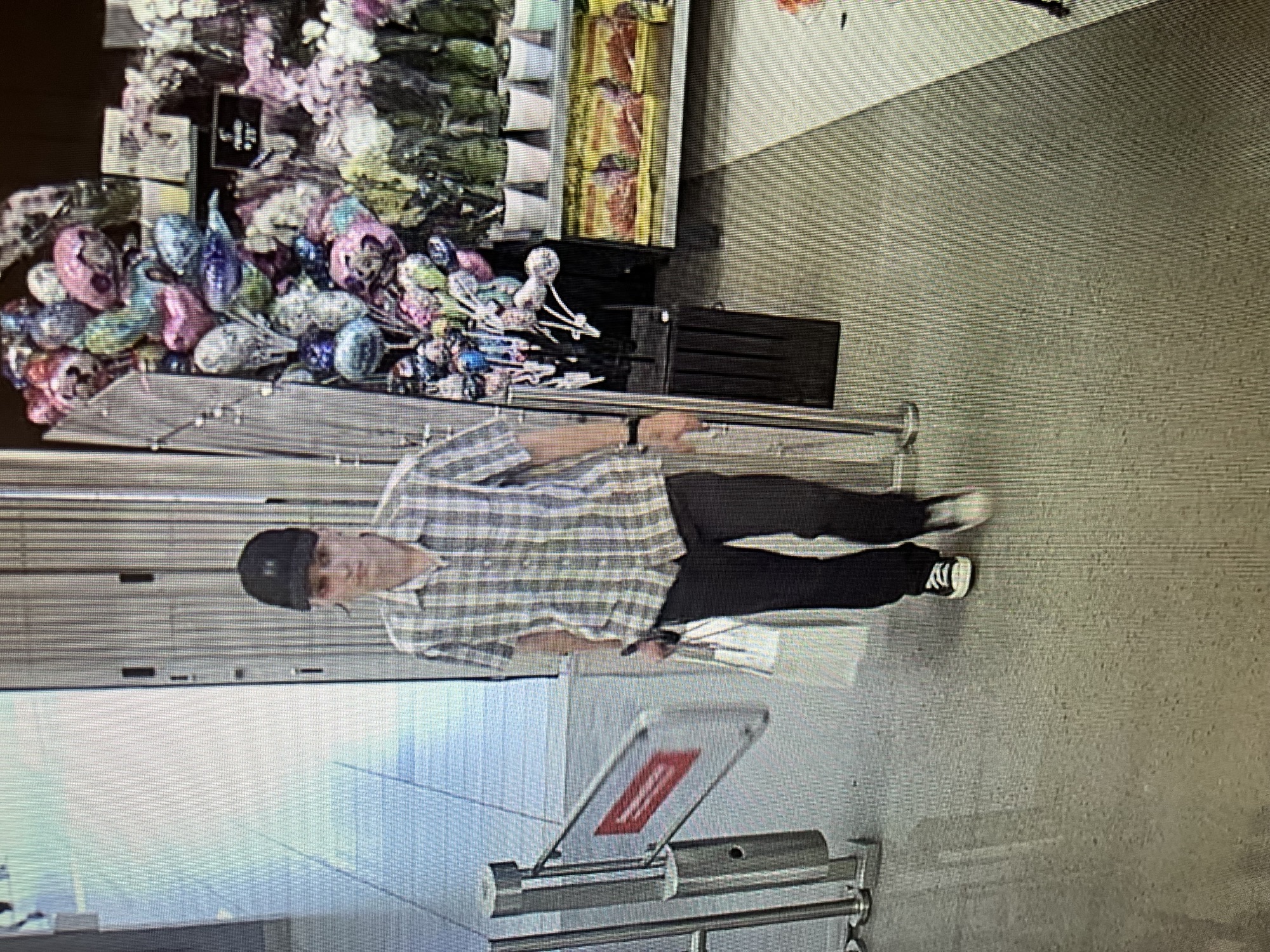 White male wearing a black ball cap, white shirt, black pants