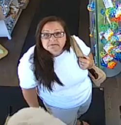 Female with long brown hair, glasses, wearing a white shit