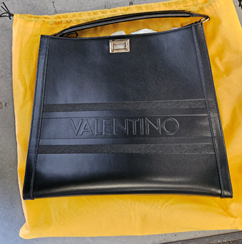 black leather bag with "Valentino" embossed on it