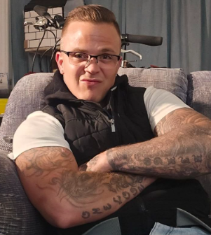 A person with tattoos on his arms

AI-generated content may be incorrect.
