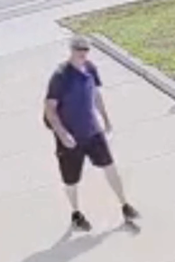 White male in his 50's, wearing blue t-shirt, black shorts, black shoes. 