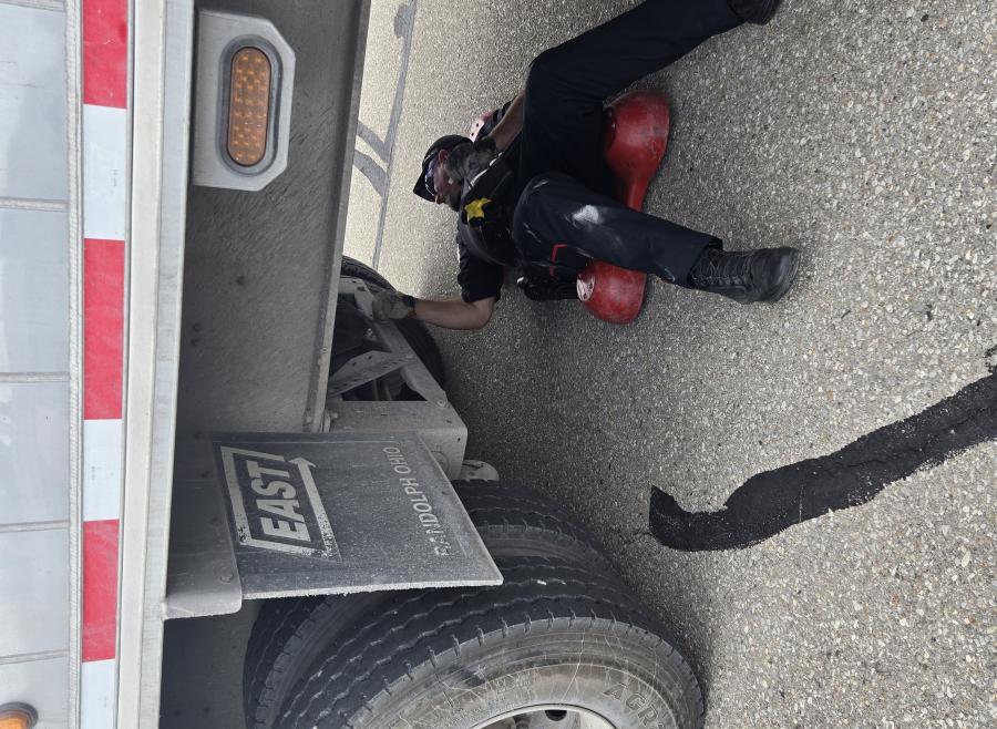 Police officer inspecting a trailer truck