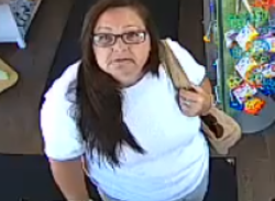 Female with long brown hair, glasses, wearing a white shit