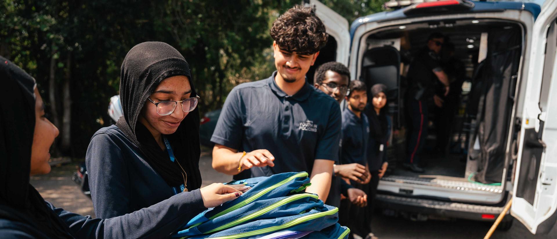 Youth handling backpacks