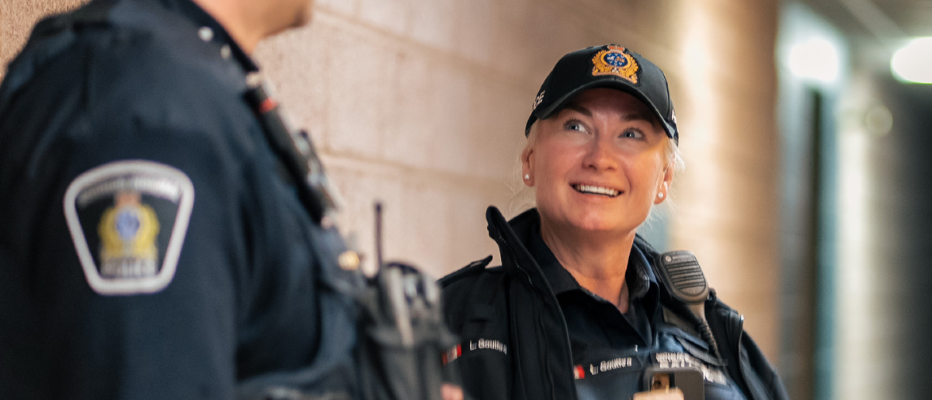 Two police officers smiling and talking with one another