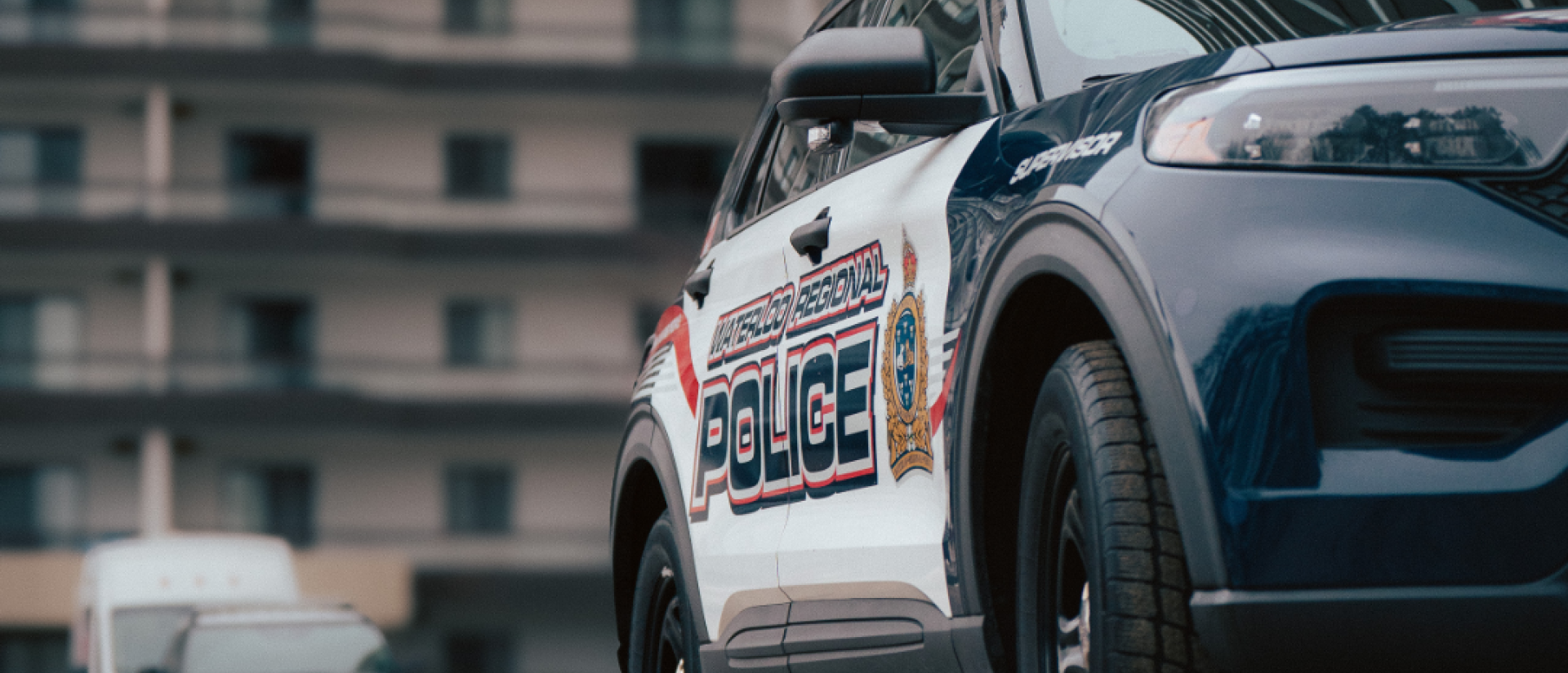 A cruiser parked outside an apartment building