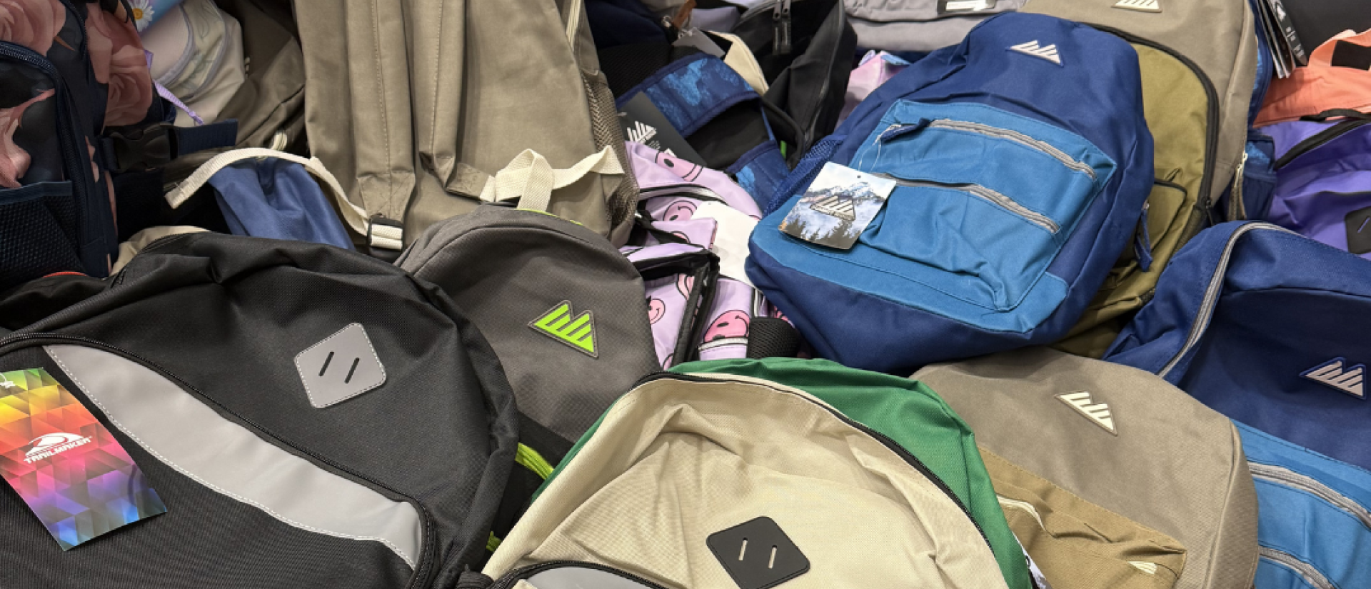 A large pile of backpacks