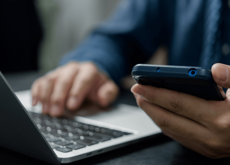 Person on computer and cell phone